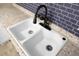 Close up of a kitchen sink with black faucet, showing detail of the countertops and backsplash at 137 Dowling Ave, Walterboro, SC 29488