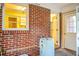 Mud room features brick accent wall and a hot water heater at 137 Dowling Ave, Walterboro, SC 29488