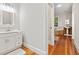 A bathroom featuring wood floors, a white vanity, and a soaking tub at 140 Old Plantation Ln, Moncks Corner, SC 29461