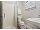 Bathroom featuring a glass enclosed walk-in shower, toilet, and pedestal sink with white trim at 140 Old Plantation Ln, Moncks Corner, SC 29461