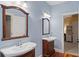 A blue bathroom featuring two wood-framed mirrors and pedestal sinks at 140 Old Plantation Ln, Moncks Corner, SC 29461
