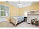 A yellow bedroom featuring a four-poster bed and a white desk at 140 Old Plantation Ln, Moncks Corner, SC 29461