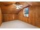 The bedroom features carpet, wood paneled walls, a window unit, and a ceiling fan at 140 Old Plantation Ln, Moncks Corner, SC 29461