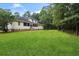 Rear exterior view of a charming two-story home, featuring a spacious backyard, perfect for outdoor activities at 140 Old Plantation Ln, Moncks Corner, SC 29461