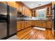 Well-lit kitchen with stainless steel appliances, wooden cabinets, and beautiful hardwood floors at 140 Old Plantation Ln, Moncks Corner, SC 29461