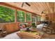 Relaxing screened porch with comfortable wicker furniture, wood paneling, and scenic views at 140 Old Plantation Ln, Moncks Corner, SC 29461