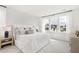 Bright bedroom features large windows, patterned accent wall, and stylish modern furnishings at 1439 Clay Field Trl, Summerville, SC 29485