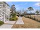 Spacious backyard with manicured lawn, stepping stone walkway, and outdoor seating area at 151 Brailsford St, Charleston, SC 29492