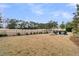 View of a sprawling backyard with lush grass, manicured landscaping, and a view of the golf course at 151 Brailsford St, Charleston, SC 29492