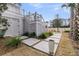 The backyard is beautifully landscaped, has a stepping stone pathway and golf course views at 151 Brailsford St, Charleston, SC 29492