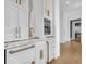 Elegant bar area featuring modern appliances, marble counters and bronze hardware at 151 Brailsford St, Charleston, SC 29492