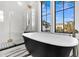Beautiful primary bathroom with a soaking tub, glass shower and marble floor at 151 Brailsford St, Charleston, SC 29492