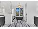 Modern bathroom boasts a soaking tub, frameless shower and sleek black and white design at 151 Brailsford St, Charleston, SC 29492