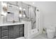Modern bathroom with white marble shower, dark vanity, and gold hardware at 151 Brailsford St, Charleston, SC 29492