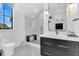 Modern bathroom with a glass enclosed shower, black and white geometric tile floor, and designer vanity at 151 Brailsford St, Charleston, SC 29492