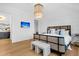 Bright bedroom with a modern bed frame, stylish lighting, and a view of the hall with custom cabinets at 151 Brailsford St, Charleston, SC 29492