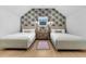Cozy bedroom featuring two beds, a wooden cabinet, and stylish wallpaper at 151 Brailsford St, Charleston, SC 29492