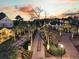 Palm-lined driveway illuminated at twilight, leading to a grand estate at 151 Brailsford St, Charleston, SC 29492