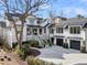 White modern farmhouse features an attached garage and elegant landscaping at 151 Brailsford St, Charleston, SC 29492