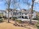 Stunning white modern farmhouse with an attached garage, lush landscaping and circular driveway at 151 Brailsford St, Charleston, SC 29492