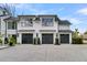 Beautiful home exterior featuring a three-car garage and lush landscaping at 151 Brailsford St, Charleston, SC 29492