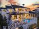 Luxury farmhouse exterior showcases a pool and outdoor living space at sunset at 151 Brailsford St, Charleston, SC 29492