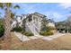 View of the backyard and patio with stepping stone walkway and lush landscaping at 151 Brailsford St, Charleston, SC 29492