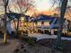 Stunning white modern farmhouse with an attached garage, lush landscaping, and twilight sky at 151 Brailsford St, Charleston, SC 29492