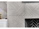 Close-up of the modern fireplace with custom tile surround, and built-in shelving at 151 Brailsford St, Charleston, SC 29492