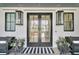 Elegant front entrance with double doors, flanked by stylish sconces and planters at 151 Brailsford St, Charleston, SC 29492
