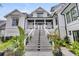 Grand home entrance featuring an elegant staircase and well-manicured landscaping at 151 Brailsford St, Charleston, SC 29492