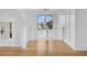 Hallway with hardwood floors, white walls, a modern chandelier, and metal railing staircase at 151 Brailsford St, Charleston, SC 29492