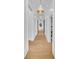 Hallway features contemporary lighting, millwork, and hardwood floors at 151 Brailsford St, Charleston, SC 29492