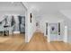 Hallway with hardwood floors, white walls, and staircase with metal railings at 151 Brailsford St, Charleston, SC 29492