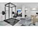 Modern home gym setup with weightlifting equipment and a flatscreen TV on the wall at 151 Brailsford St, Charleston, SC 29492