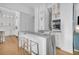 Open kitchen with island, bar stools, and marble accents with beverage center at 151 Brailsford St, Charleston, SC 29492