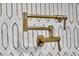 Close-up of a kitchen with gold pot filler and geometric backsplash at 151 Brailsford St, Charleston, SC 29492