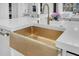 Farmhouse sink featuring gold hardware, contrasting with crisp white countertops at 151 Brailsford St, Charleston, SC 29492