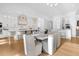 Open kitchen with dining table, and large island with seating and statement lighting at 151 Brailsford St, Charleston, SC 29492