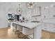 Spacious kitchen with central island, statement lighting, and integrated appliances at 151 Brailsford St, Charleston, SC 29492