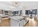 Bright open concept kitchen features a large island, stylish light fixtures, and stainless steel appliances at 151 Brailsford St, Charleston, SC 29492