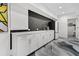 Well-appointed kitchenette with sleek white cabinets, contrasting backsplash, and stainless steel appliances at 151 Brailsford St, Charleston, SC 29492