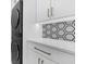 Laundry room featuring modern appliances, quartz countertops, and hexagon tile backsplash at 151 Brailsford St, Charleston, SC 29492