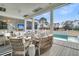 This bright living room features wicker furniture and a view of the pool at 151 Brailsford St, Charleston, SC 29492