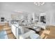 Bright and airy living room with hardwood floors, stylish decor, and adjacent kitchen area at 151 Brailsford St, Charleston, SC 29492