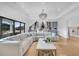 Bright living room with large sectional sofa, marble wet bar, and large windows at 151 Brailsford St, Charleston, SC 29492