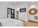 Bright bedroom features a large bed, tv and decor accents with outside access to pool at 151 Brailsford St, Charleston, SC 29492