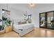A bright bedroom offers a large bed, patterned wall and modern lighting and furniture at 151 Brailsford St, Charleston, SC 29492