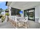 Outdoor kitchen and covered patio area with a grill, bar seating, and a flatscreen TV at 151 Brailsford St, Charleston, SC 29492
