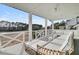Spacious outdoor patio with white furniture, ceiling fan, and a beautiful view at 151 Brailsford St, Charleston, SC 29492